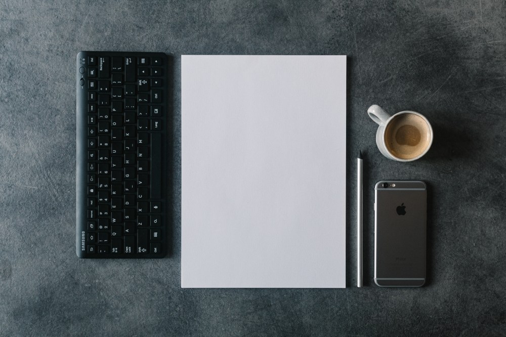 kaboompics.com_Blank white paper with pencil, glasses, black keyboard and cup of coffee
